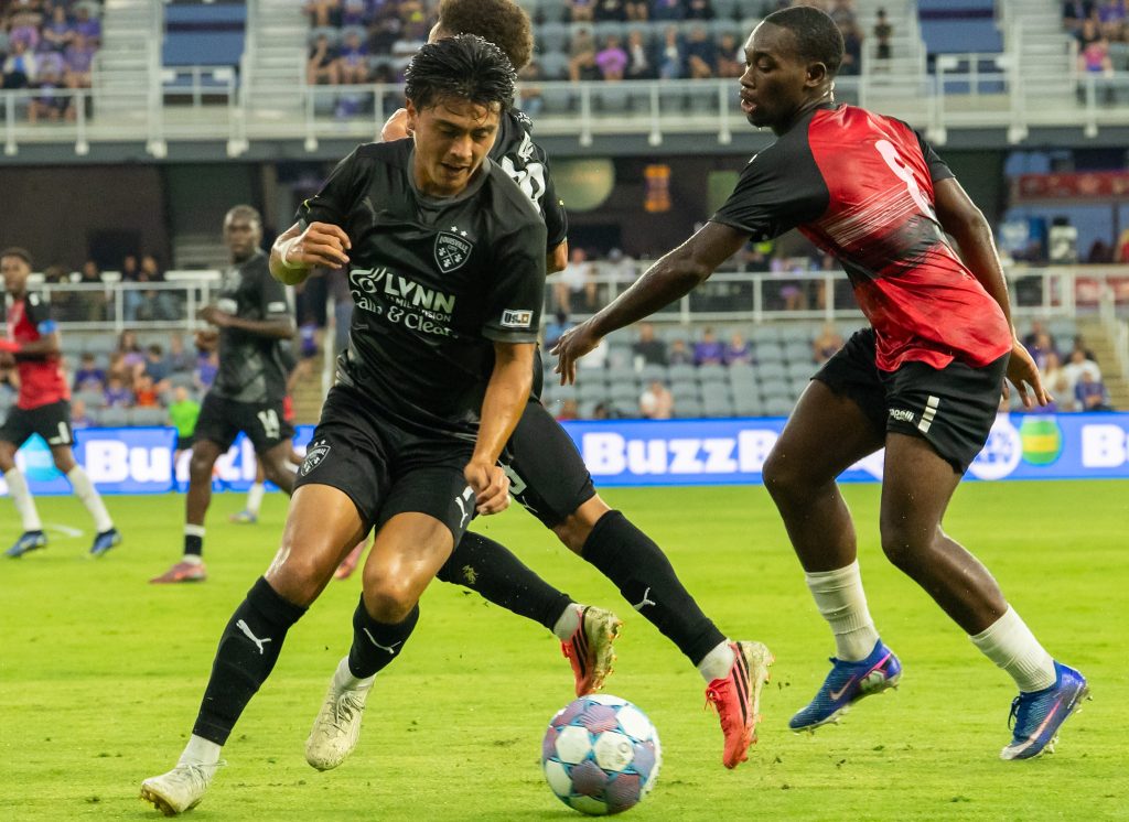 Midfielder for Louisville City taking on Trinidad and Tobago defenders