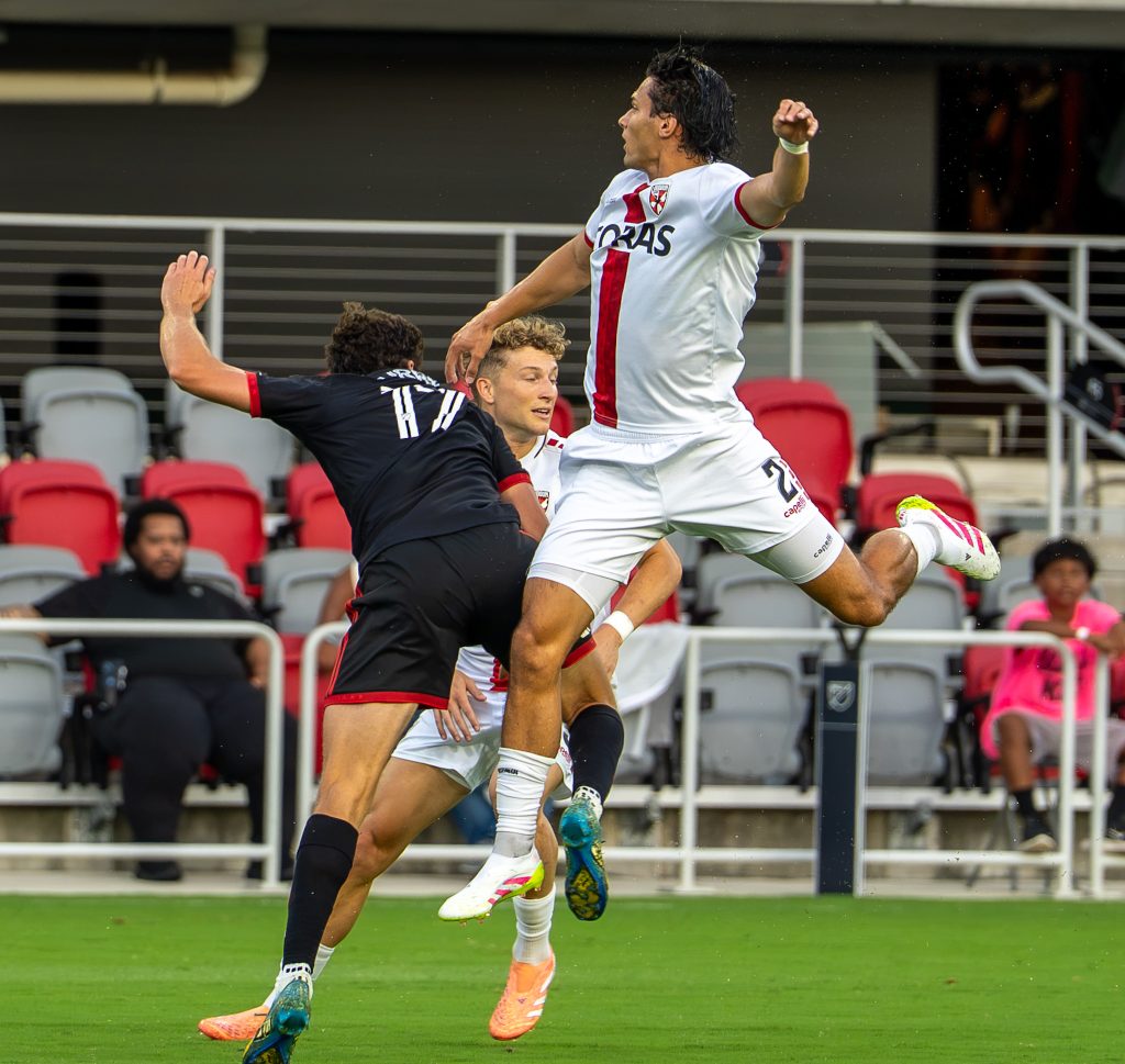 Continued airborne contests for possession between DC United and Loudon United