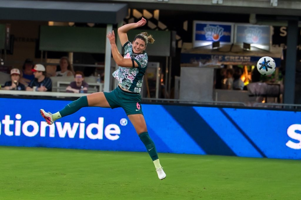 Washington Spirit player trying to connect with an airborne ball against NC Courage