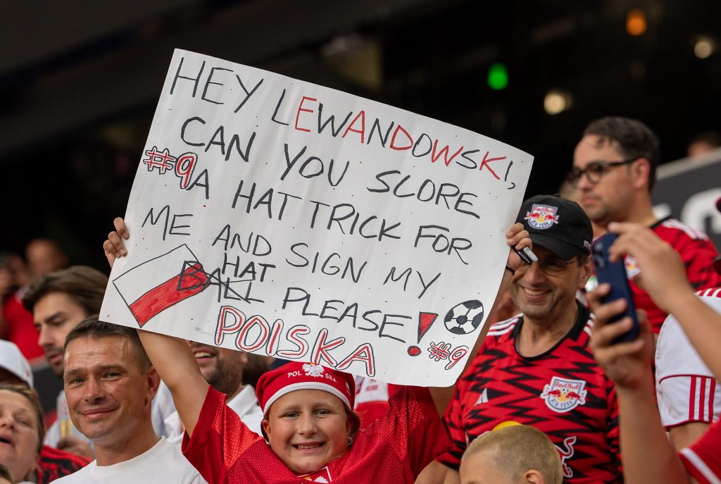 Young fans hold up signs for their favorite player
